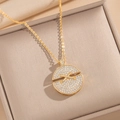 Golden round necklace with X-shaped crystal pavé pendant displayed in a brown jewelry box - Gold Necklace (8915)