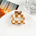 Macro detail of the square checkered hair claw clip on a minimalist ceramic plate - 5cm Square Block / Orange White Checkerboard