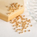 Macro shot of 14k gold-filled round spacer beads with spiral textured finish for DIY jewelry - 3mm / 14K Gold