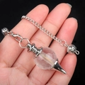 Hand holding silver chain pendant with a transparent cone-shaped natural crystal stone - White Crystal