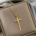 Macro shot of gold cross pendant featuring artistic patience lettering on silk - patience / Gold