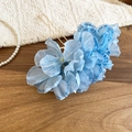 Close-up of elegant blue fabric flower hair pin with golden U-shaped metal waves - Blue