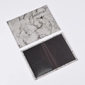 Detail view of marble pattern passport holder with internal card slots and gray finish - Gray