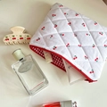 Quilted white cosmetic bag with red cherry embroidery and zipper closure for travel - Cherry Print / White