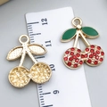 DIY cherry pendant charm with red rhinestones and green enamel leaf next to a ruler - Drip Oil Red Rhinestone Cherry (23424)