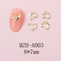 Macro detail of 8x7mm hollow heart nail art charms in golden metal finish - Gold Irregular Hollow Heart (A003)