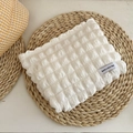 White bubble textured makeup bag with Have a Nice Day label on a woven mat - Bubble Storage Bag - White
