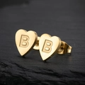 Macro view of gold heart-shaped stud earring with brushed texture and letter B engraving - Letter B / Gold