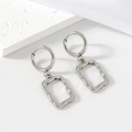 Silver stainless steel geometric earrings with square hammered texture on stone background - Steel