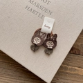 Detail of handcrafted brown crochet bunny hair ties with pearls on a display card - Pearl Rabbit Flower Hair Tie