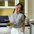 Lifestyle shot of a woman wearing a large silver heart pendant necklace in a vintage kitchen - Silver Large Heart