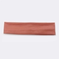 Single pink cotton sports sweatband for running laid flat on a white background - Coral Orange