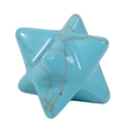 Detailed macro view of a turquoise Merkaba star pendant with natural brown textures - Turquoise