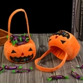 Orange plush pumpkin trick-or-treat bags with black Halloween face embroidery - Cotton Filled Pumpkin Jar