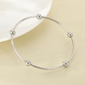 Macro detail of silver minimalist bangle featuring five polished spherical metal beads - Inner Diameter 60mm / Single Ring / Steel