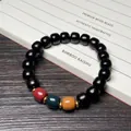 Pulsera de madera de ébano marrón oscuro con cuentas de colores sobre libro caligráfico - Ébano de Mozambique Cuentas de Tres Colores Estilo Antiguo