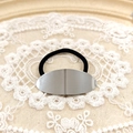 Minimalist black hair tie with polished oval silver alloy charm on lace background - Silver Smooth Oval