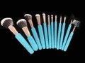 Detail of 10 blue rhinestone makeup brushes with gold ferrule in fan-shaped arrangement - Lake Blue