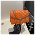 Orange quilted handbag with V-stitch pattern, metal chain, and heart-shaped clasp - Orange