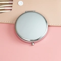 Portable silver round folding makeup mirror with a pink background and leather pouch - 65mm / Chrome