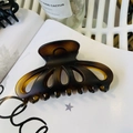 Detail of large dark brown tortoiseshell hair claw clip with hollow petal design - Matte Light Tortoise
