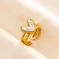 Detailed macro view of a gold heart-shaped ring with white marble stone inlay - Adjustable Open / Gold - White Marble Texture