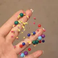Macro detail of colorful resin beads on jewelry wire for vintage circular earrings - 925 Sterling Silver Earring Post Colorful Beaded (12#)