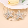 Close-up of starfish stud earrings with white micro pearls and sparkling AB crystals - Iridescent White