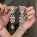 Detail of elegant silver tassel earrings with crystal flowers held in hands - 11# Silver Pin - Silver