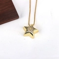 Detail shot of a golden star pendant with a zircon-inlaid letter Q on a snake chain - Letter Q