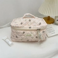 Pink quilted cotton makeup bag with cute rabbit patterns and zipper closure in a cozy setting - Purple Bowknot Rabbit