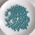 Macro view of cylindrical light blue acrylic tube beads in a white ceramic dish - 6# Sky Blue