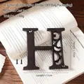 Industrial cast iron letter H wall decor with vintage brown finish and mounting screws - Letter H