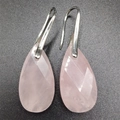 Macro shot of faceted pink quartz teardrop earrings with silver metal hooks on dark base - 13*25*6MM / Rose Quartz