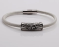 Close-up of white braided bracelet with silver metal cylinder and magnetic clasp - Platinum N