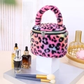 Detail of the soft plush texture and vibrant rainbow leopard print on a cylindrical bag - Rose Red