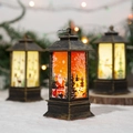 Close-up of a vintage Christmas lantern with Santa Claus pattern and warm LED glow - Starry Small Santa / Gold