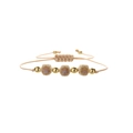 Handmade woven bracelet with ceramic flower charms and golden beads on white background - Copper Beads + Light Ocher Flowers