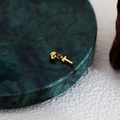 Golden letter T pendant with a polished finish and small bead ring on marble surface - Letter Pendant (T) / Gold