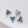 Silver lobster pendants with teal zircon stones set on a white ceramic plate - Silver with Blue Zirconia Lobster