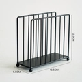 Modern black metal napkin holder with minimalist grid frame and spherical feet support - Black