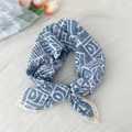 Light blue geometric silk scarf with lace trim shown in a stylish natural knot tie - Blue Geometric Block