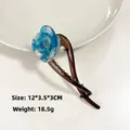 Pinza para el cabello con rosa de acetato azul jaspeado y base marrón translúcida - Azul transparente