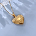 Detailed view of golden heart locket with floral engravings and fine O-chain necklace - With Cable Chain / Gold