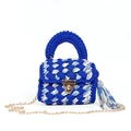 Detail view of blue and white handmade knit bag with gold chain and tassel charm - Blue White Gray Stripes