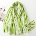 Detail of light green and white striped scarf with silver glitter and fringe edges - Green