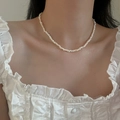 Close-up of elegant baroque freshwater pearl necklace worn with a white lace blouse - Style 3 Freshwater Pearl