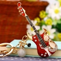 Red electric guitar keychain with cat eye stones, gold lobster clasp and pearl pendant - Single OPP Bag Packaging / Romantic Guitar