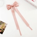 Pink satin ribbon bow hair clip with long streamers on a minimalist white background - Satin / Pink