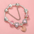 Detailed macro view of silver-plated heart beads and pink crystals on a charm bracelet - Sl023318/1216-24